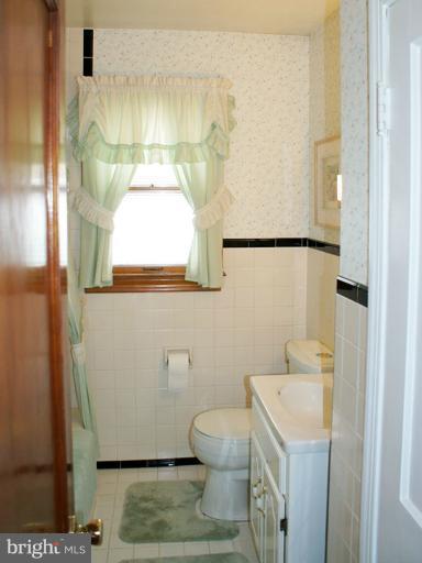 22 Mansion Road Linthicum Heights, MD 21090 - Photo 15 of 20 a bathroom with a sink a toilet and a mirror