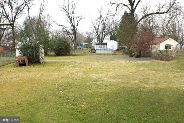 22 Mansion Road Linthicum Heights, MD 21090 - Photo 8 of 20 a view of a yard with a house and large trees