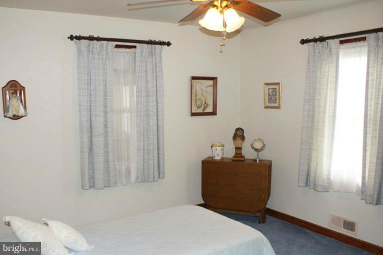 22 Mansion Road Linthicum Heights, MD 21090 - Photo 9 of 20 a bedroom with a bed and a chandelier