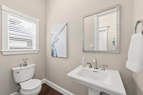 a bathroom with a sink mirror and toilet