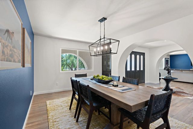 a view of a dining room with a table and chairs