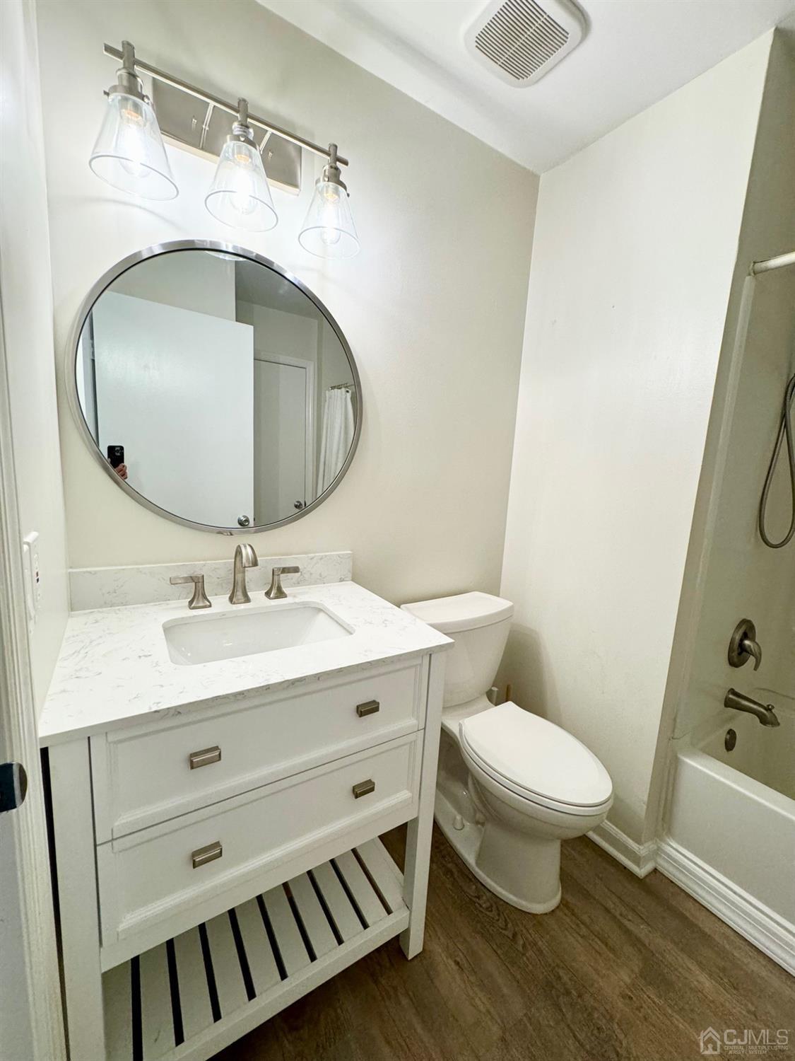 120 Edpas Road New Brunswick, NJ 08901 - Photo 3 of 15 a bathroom with a sink mirror vanity and toilet