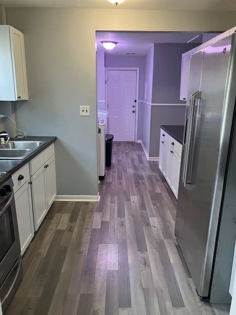 1432 Ridgeway Street Round Lake Beach, IL 60073 - Photo 12 of 20 a kitchen with sink a refrigerator and wooden floor
