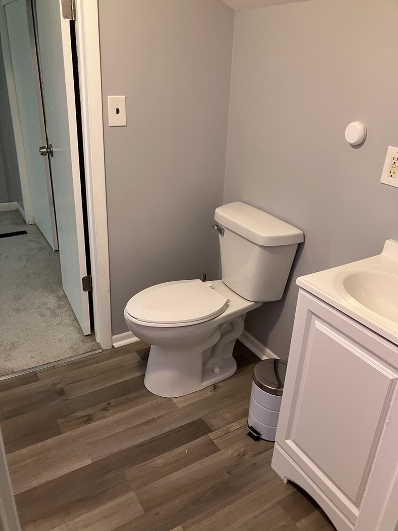 1432 Ridgeway Street Round Lake Beach, IL 60073 - Photo 15 of 20 a bathroom with a toilet and a sink