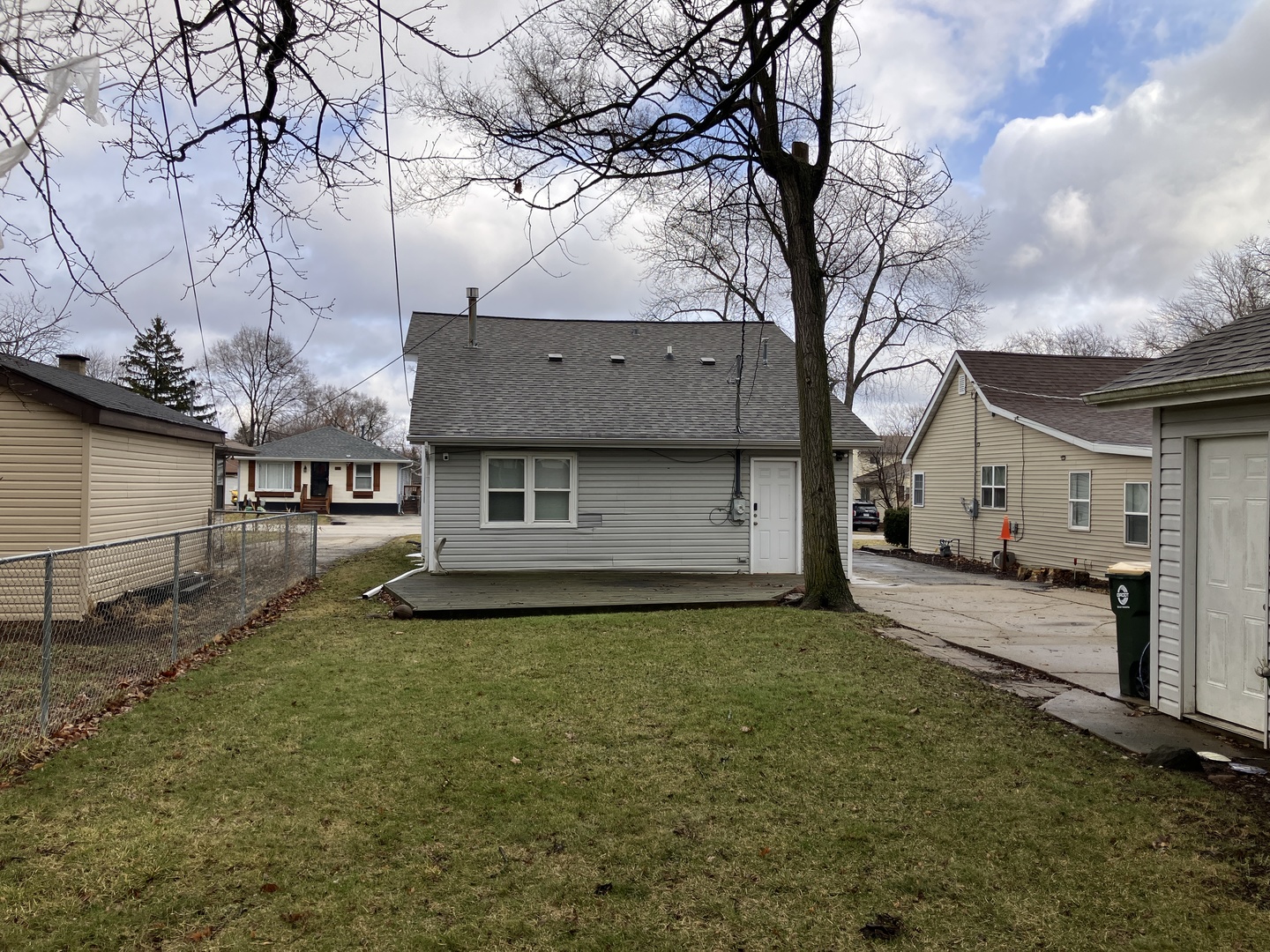 1432 Ridgeway Street Round Lake Beach, IL 60073 - Photo 4 of 20 a view of a house with a large tree and a yard