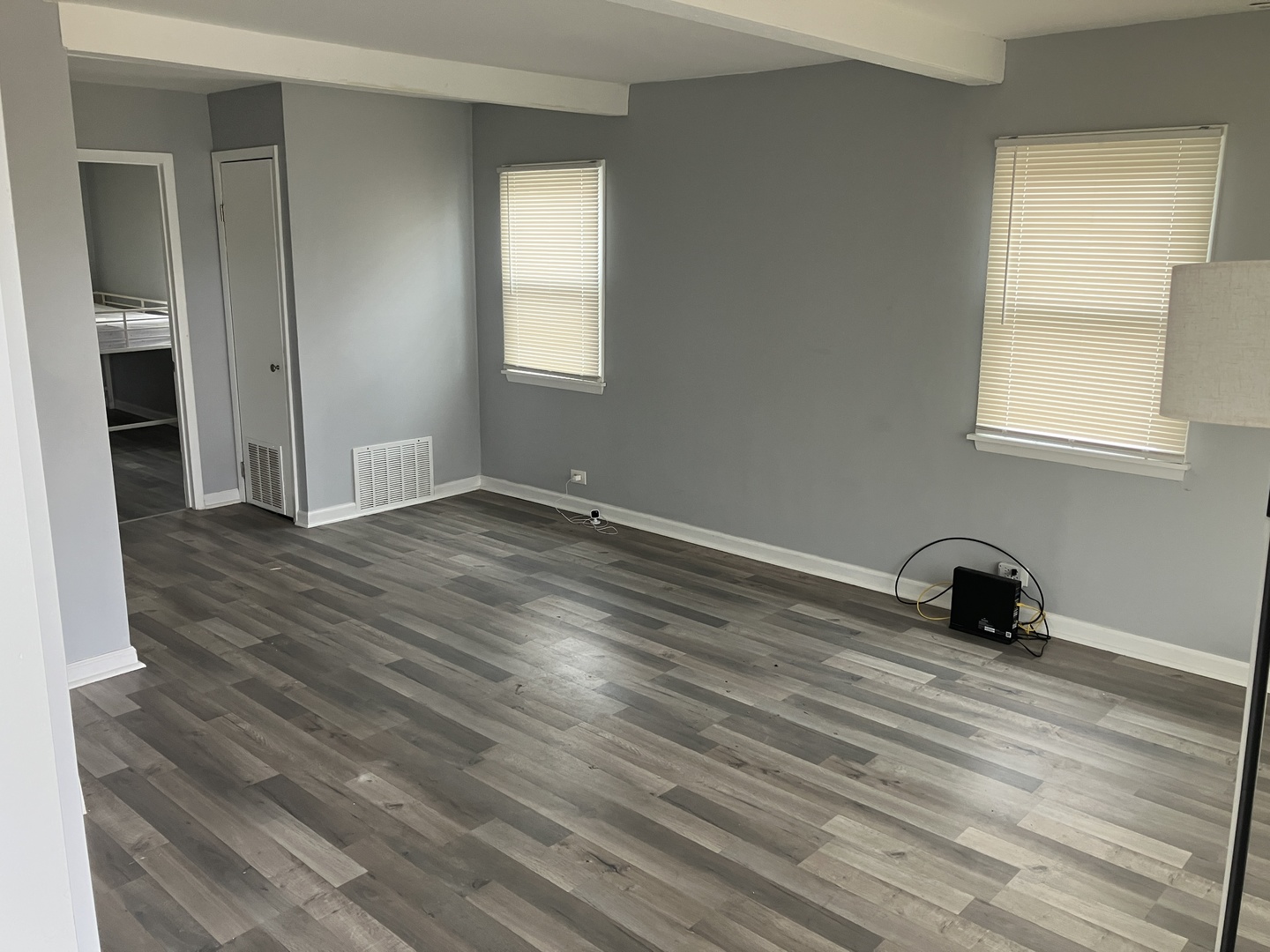 1432 Ridgeway Street Round Lake Beach, IL 60073 - Photo 5 of 20 an empty room with wooden floor and windows