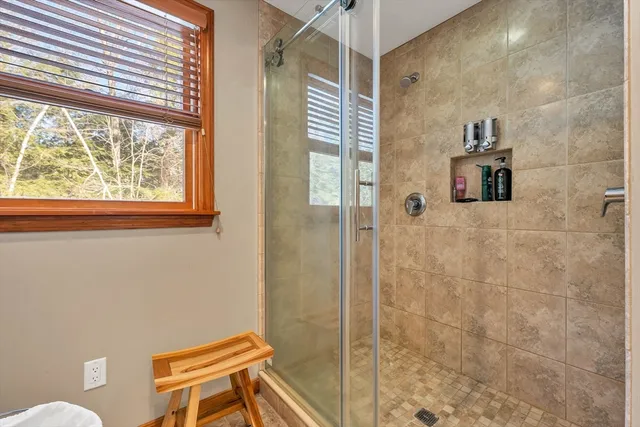 a bathroom with a toilet and a shower