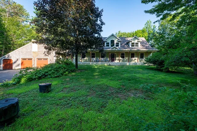 a front view of a house with a yard table and chairs