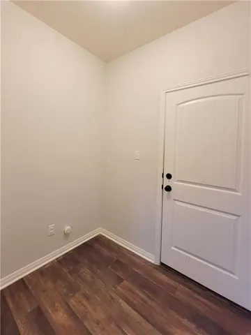 an empty room with wooden floor