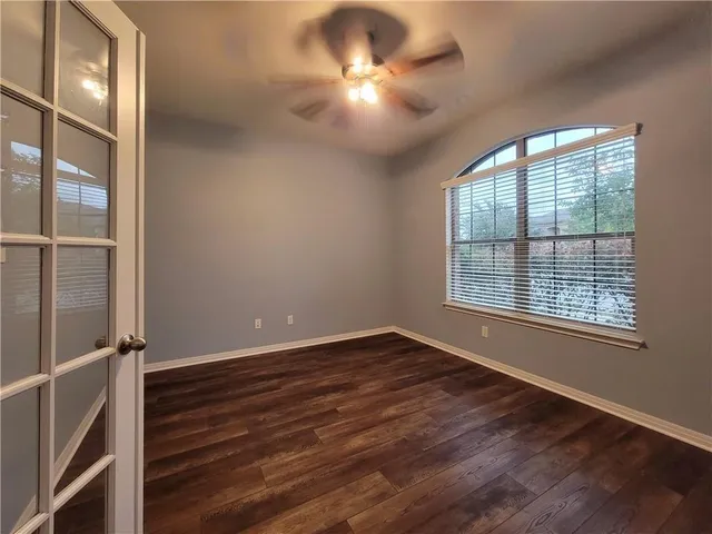 wooden floor in an empty room with a window