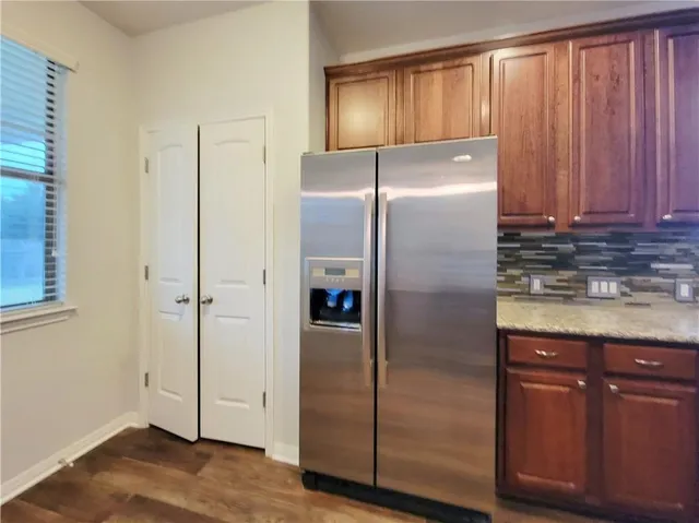 a bathroom with a refrigerator and a sink