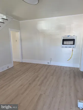 a view of a room with wooden floor