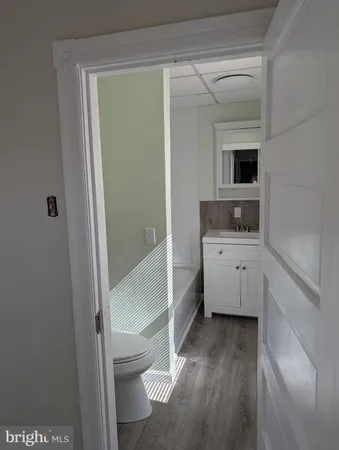 a view of bathroom with a toilet sink and mirror
