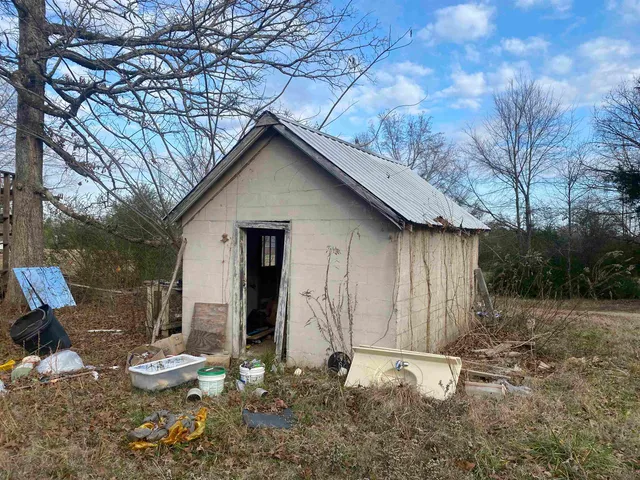 a backyard of a house with table and chairs