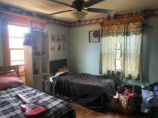 a bedroom with bed and a window