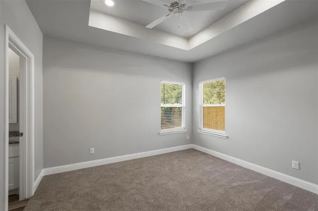 an empty room with a empty space and windows