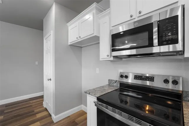 a kitchen with stainless steel appliances granite countertop a stove and a microwave