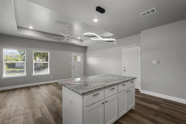 an empty room with wooden floor and window