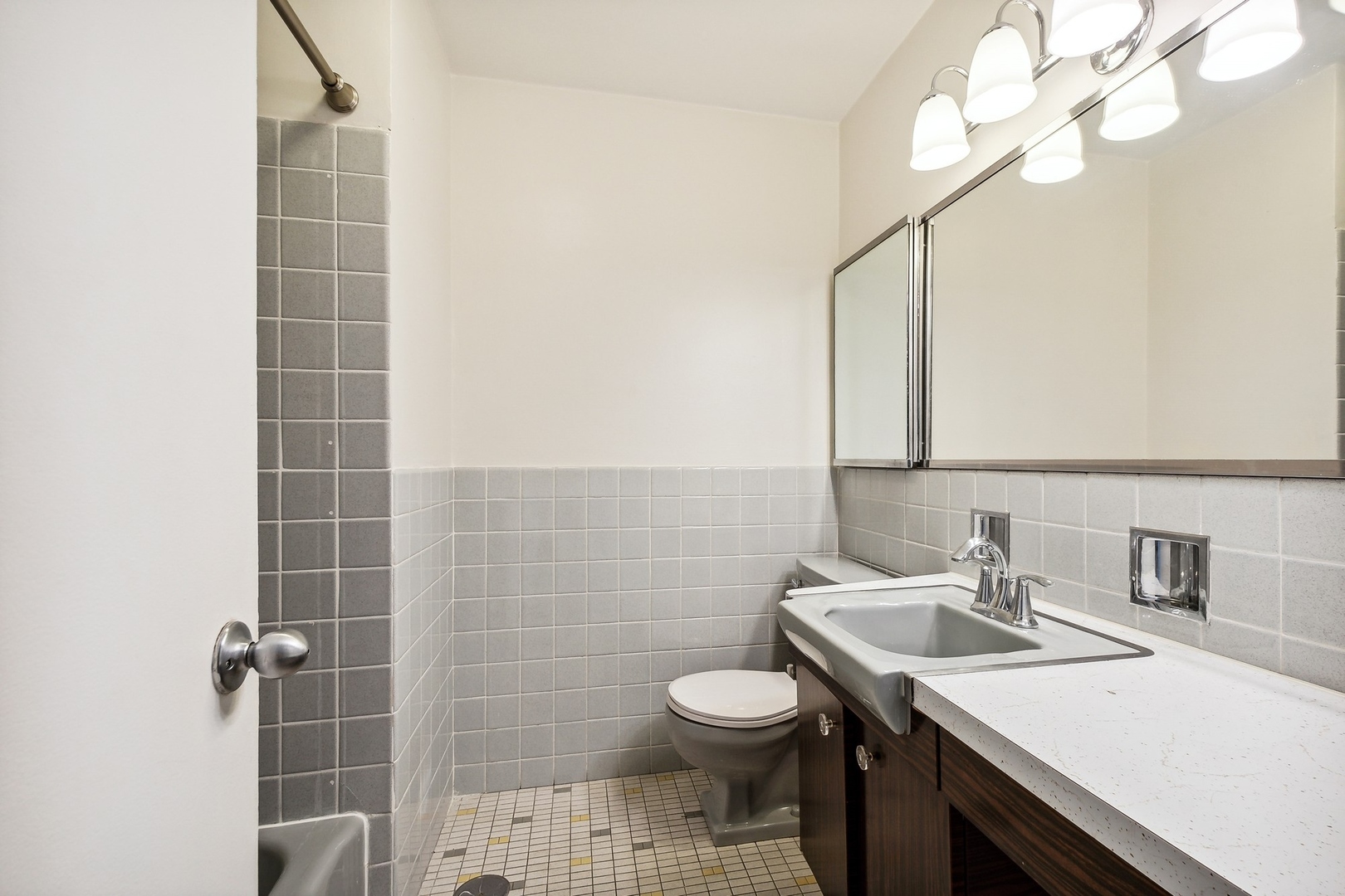 5701 North Sheridan Road, Unit 5K Chicago, IL 60660 - Photo 17 of 24 a bathroom with a sink a toilet and a mirror