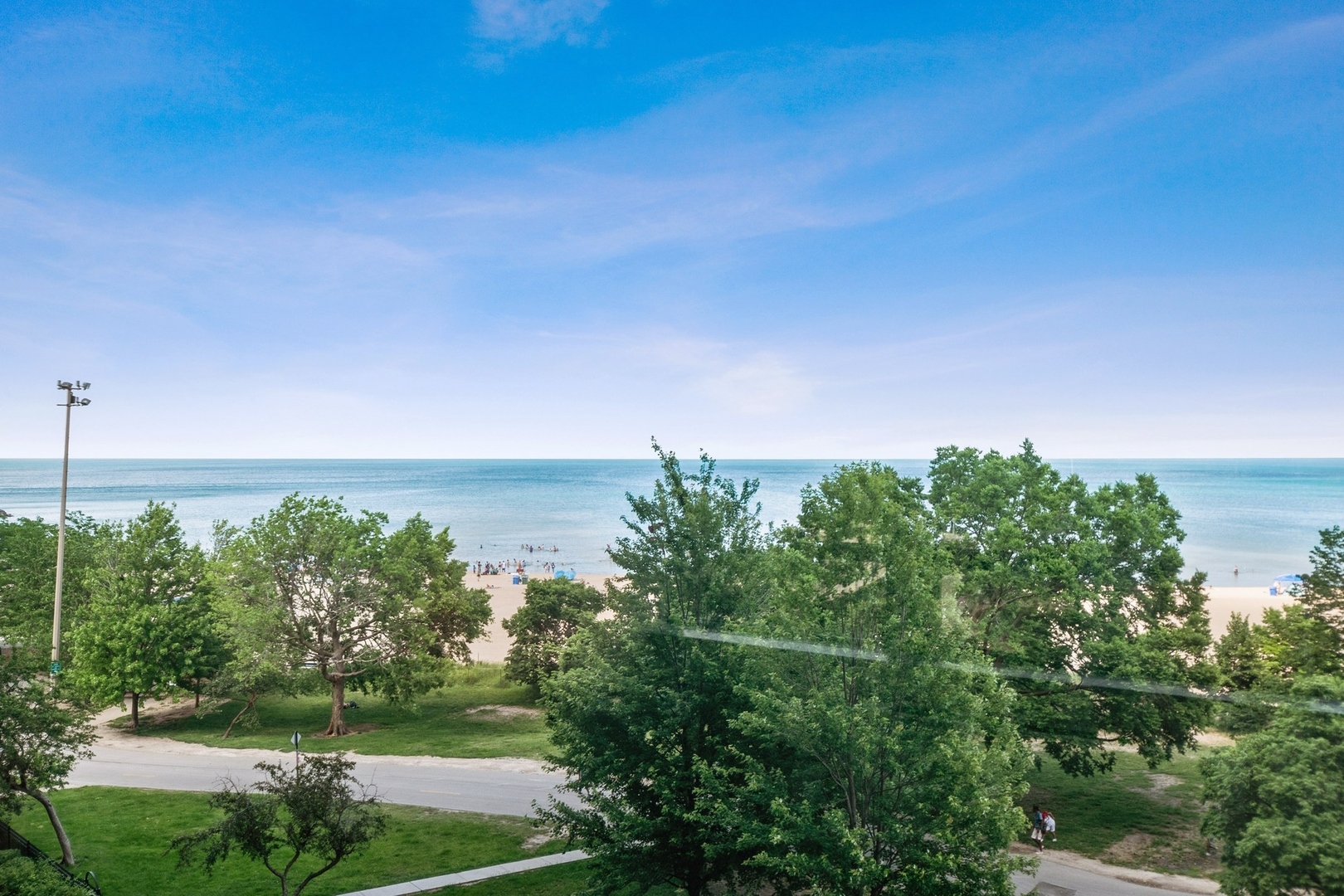 5701 North Sheridan Road, Unit 5K Chicago, IL 60660 - Photo 18 of 24 a view of a city with lush green forest