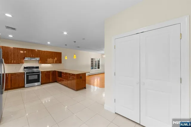 a kitchen with stainless steel appliances a refrigerator and a sink