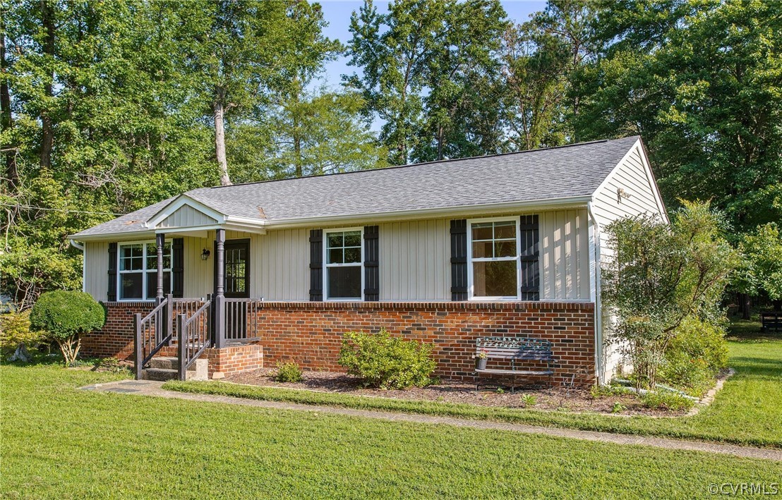 14020 Westfield Road Midlothian, VA 23113 - Photo 3 of 29 a front view of a house with a yard table and chairs