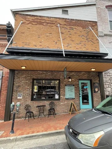 a view of living room with furniture and fireplace