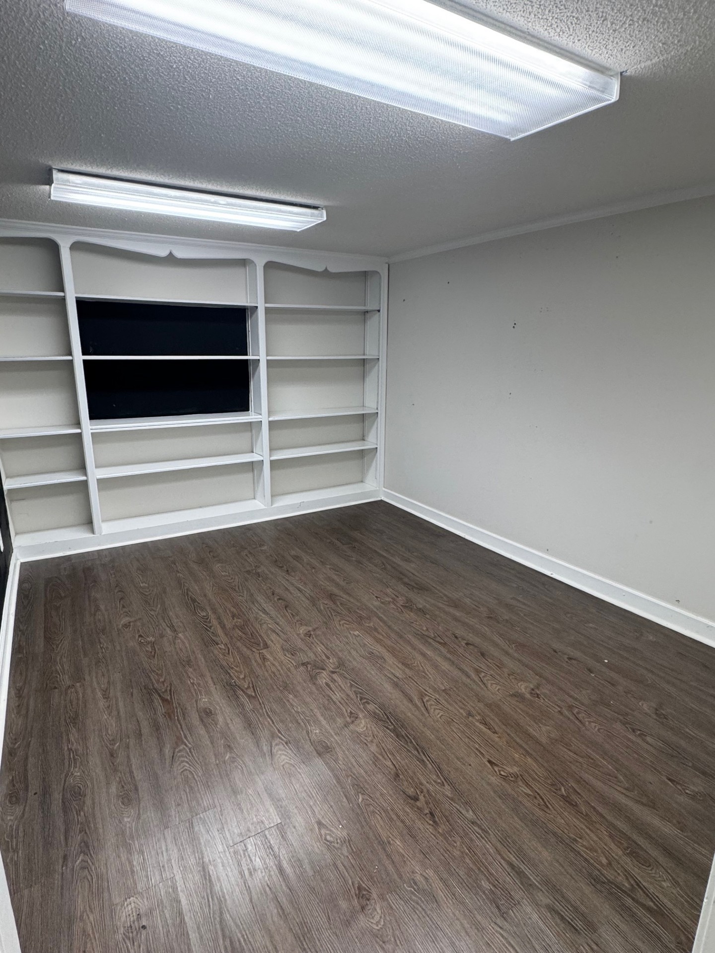 137 Franklin Street Clarksville, TN 37040 - Photo 11 of 16 a view of an empty room with wooden floor and a window