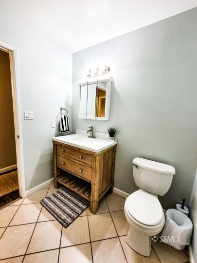 521 Sydnor Avenue Ridgecrest, CA 93555 - Photo 17 of 28 a bathroom with a sink toilet and mirror