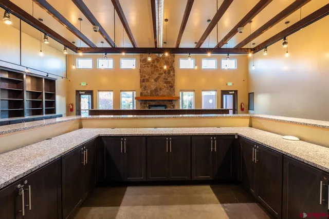 a bathroom with a sink and a large mirror next to a window