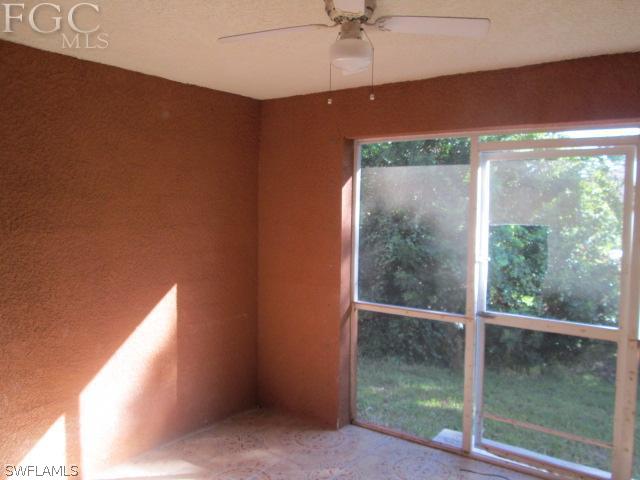 113 Meadow Road Lehigh Acres, FL 33973 - Photo 8 of 10 an empty room with a window