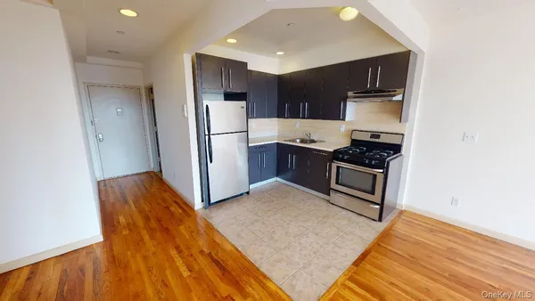a kitchen with stainless steel appliances granite countertop a refrigerator stove and sink