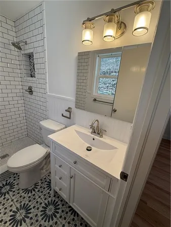 a bathroom with a toilet and a shower
