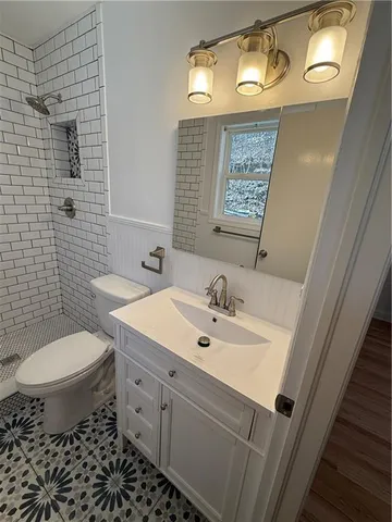 a bathroom with a toilet and a shower