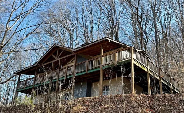 a view of a house with a small yard and wooden fence