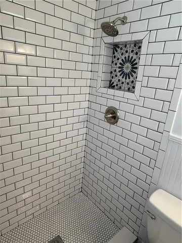 a living room with fireplace and a wooden floor