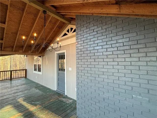a view of a porch with wooden floor