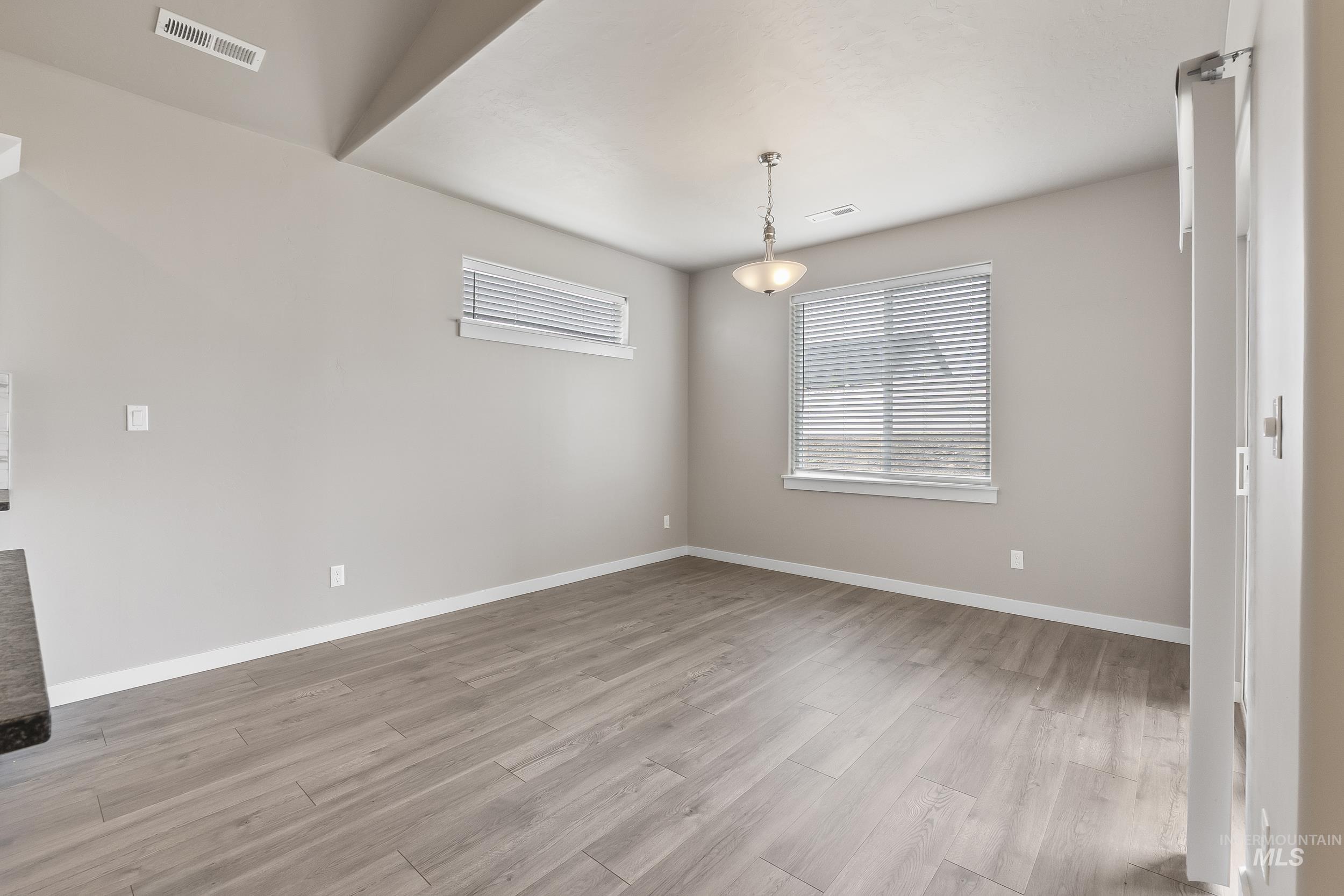 10308 West Trident Ridge Drive Star, ID 83669 - Photo 22 of 42 Empty room with light wood-style flooring and healthy amount of natural light