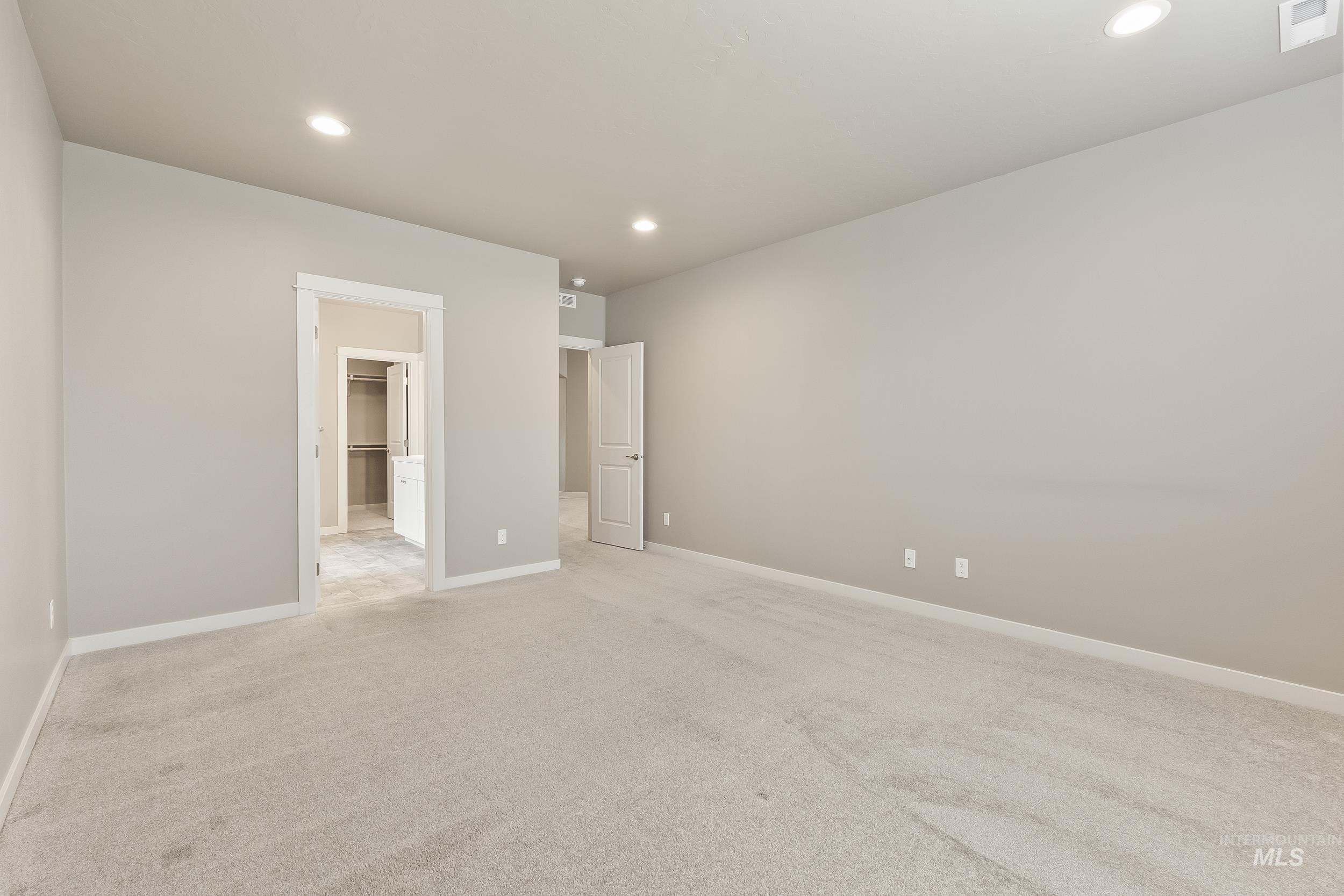 10308 West Trident Ridge Drive Star, ID 83669 - Photo 23 of 42 Unfurnished bedroom with light colored carpet, recessed lighting, and ensuite bath