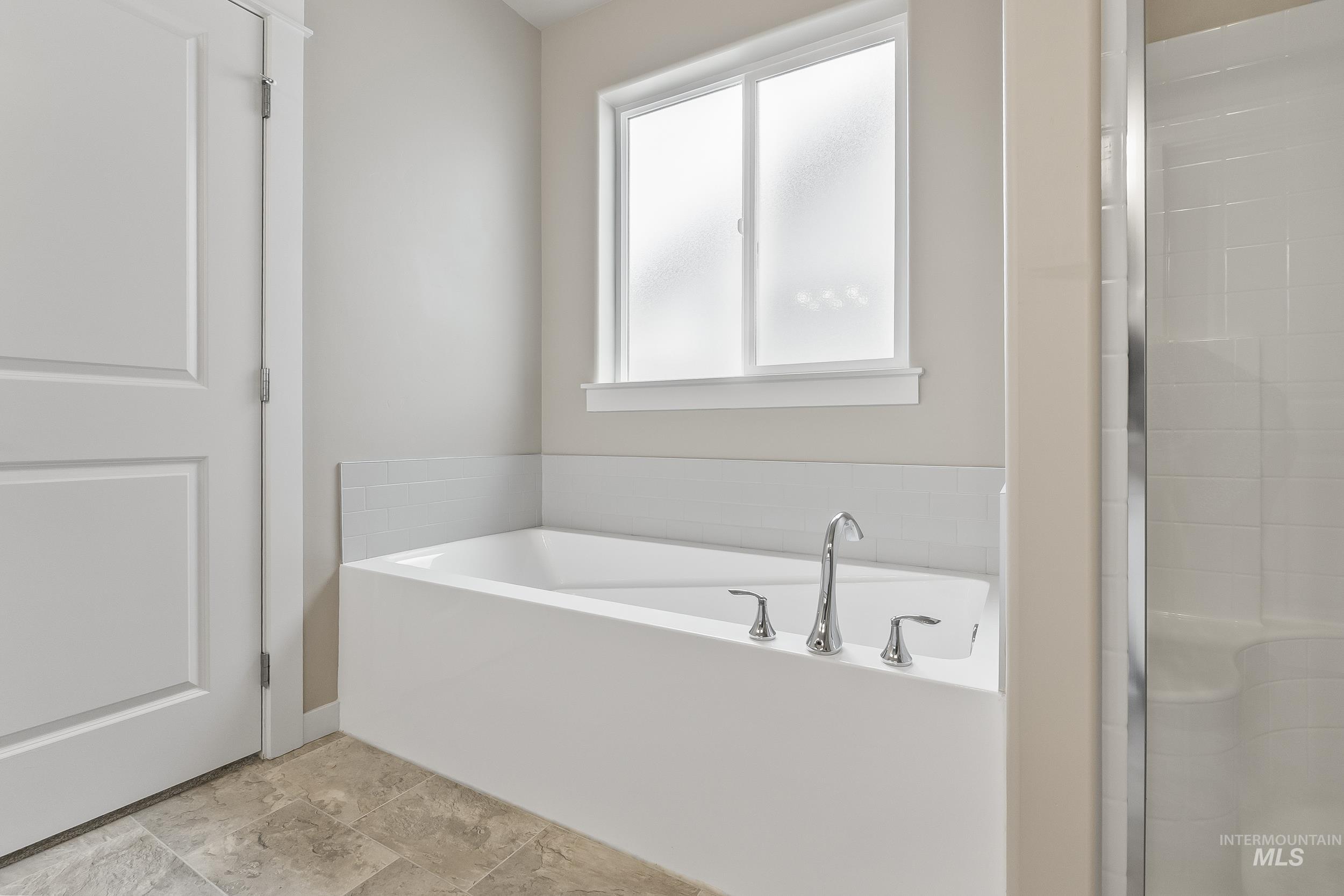10308 West Trident Ridge Drive Star, ID 83669 - Photo 25 of 42 Full bath with a garden tub and a shower stall