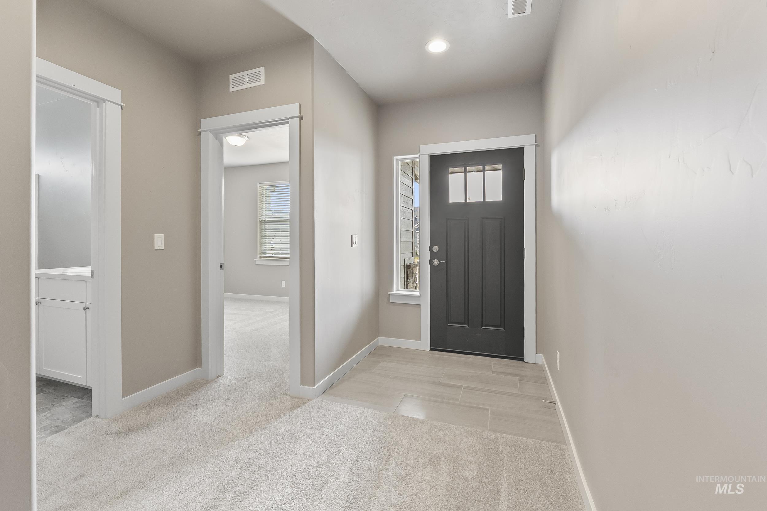 10308 West Trident Ridge Drive Star, ID 83669 - Photo 28 of 42 Foyer featuring light carpet and baseboards