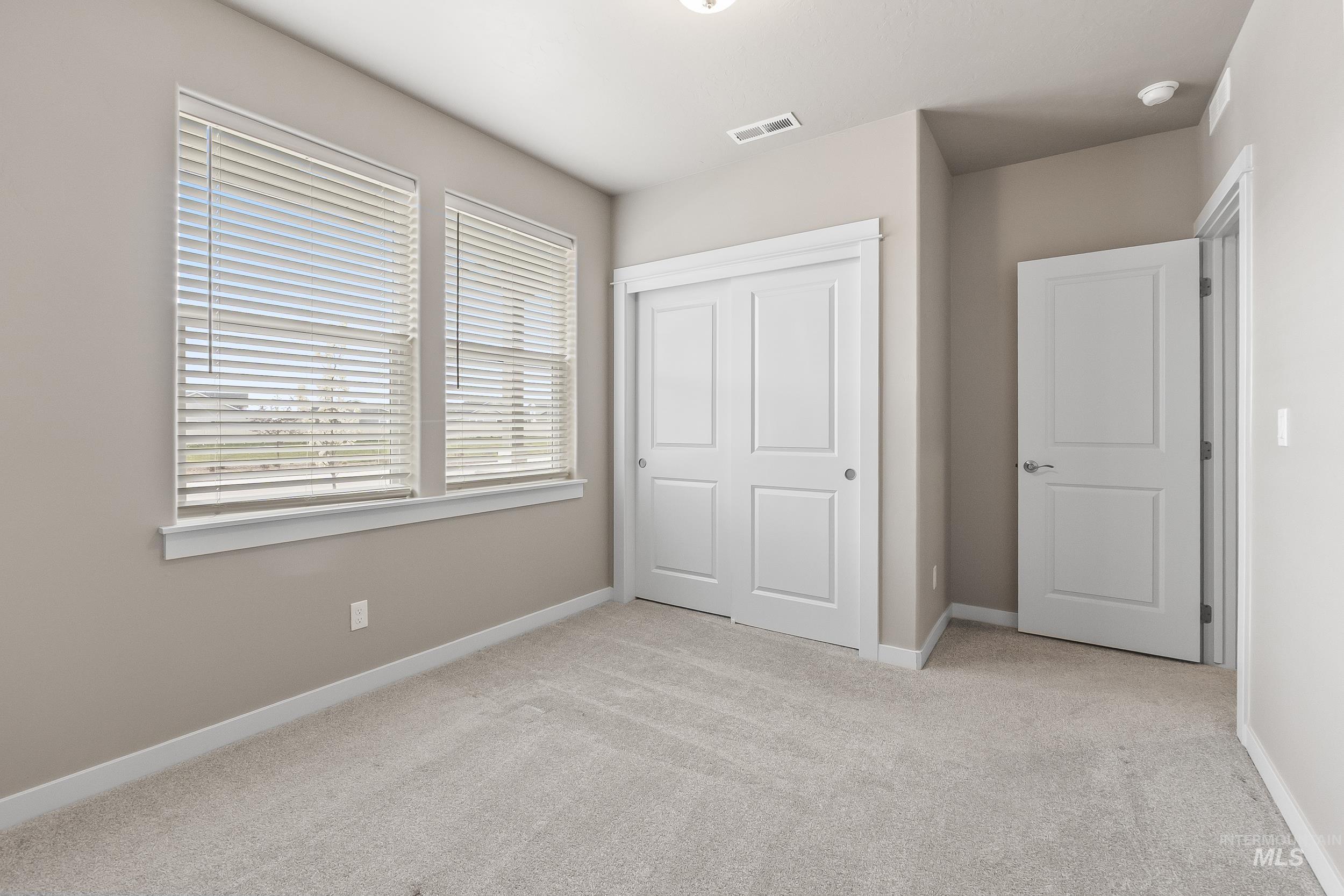 10308 West Trident Ridge Drive Star, ID 83669 - Photo 30 of 42 Unfurnished bedroom featuring light colored carpet and a closet