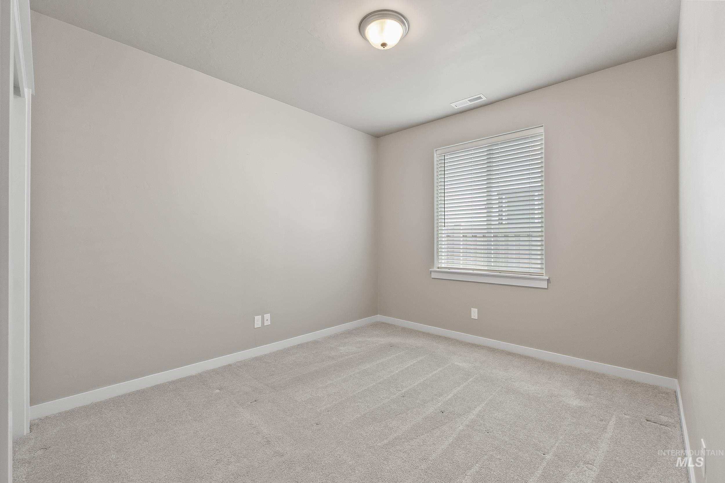 10308 West Trident Ridge Drive Star, ID 83669 - Photo 32 of 42 Spare room featuring light carpet and baseboards