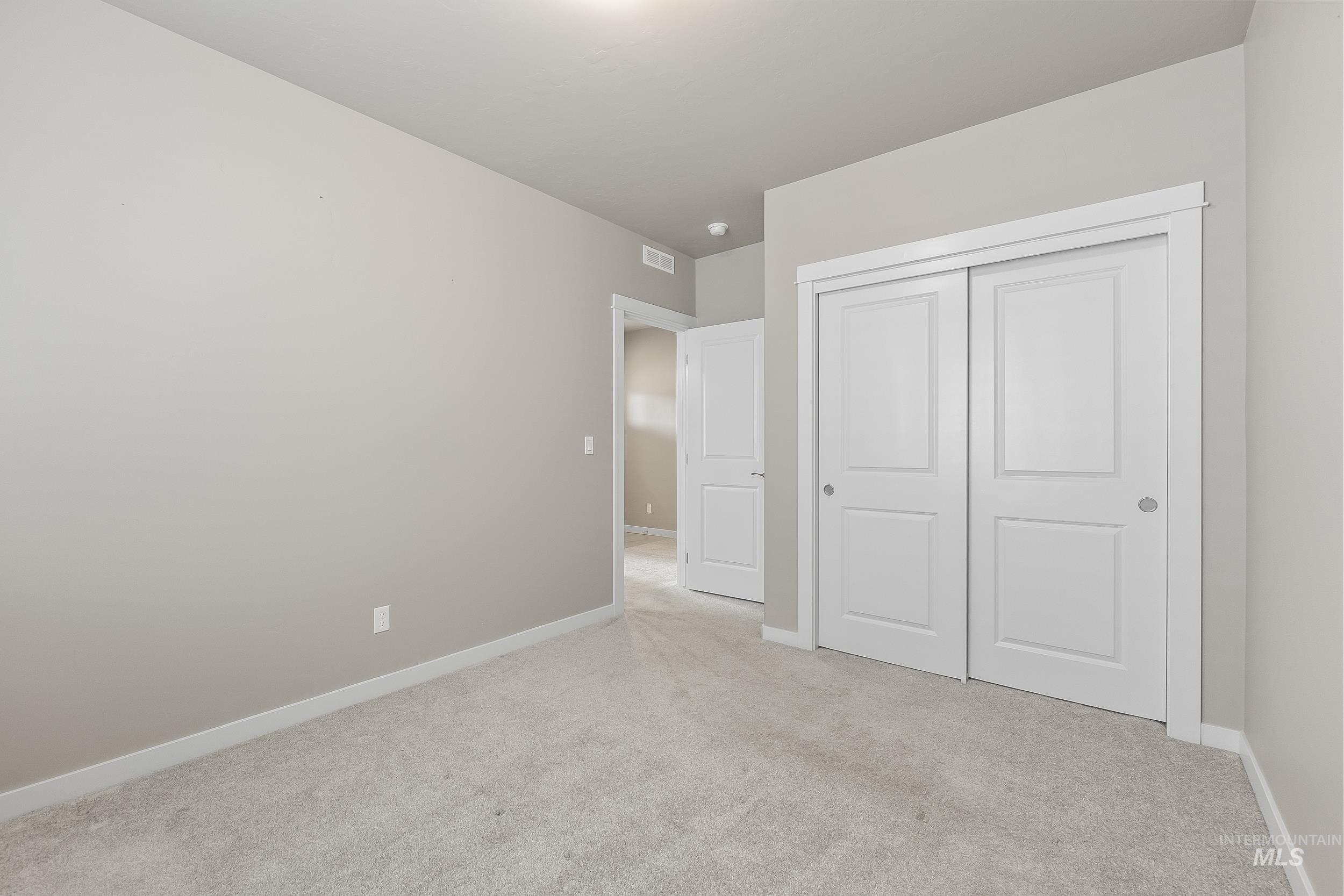 10308 West Trident Ridge Drive Star, ID 83669 - Photo 33 of 42 Unfurnished bedroom featuring light carpet and a closet