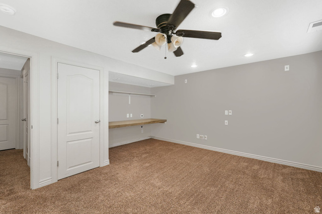 7936 Wycliffe Way Eagle Mountain, UT 84005 - Photo 24 of 37 4th bedroom featuring built in study area, carpet, recessed lighting, and a ceiling fan