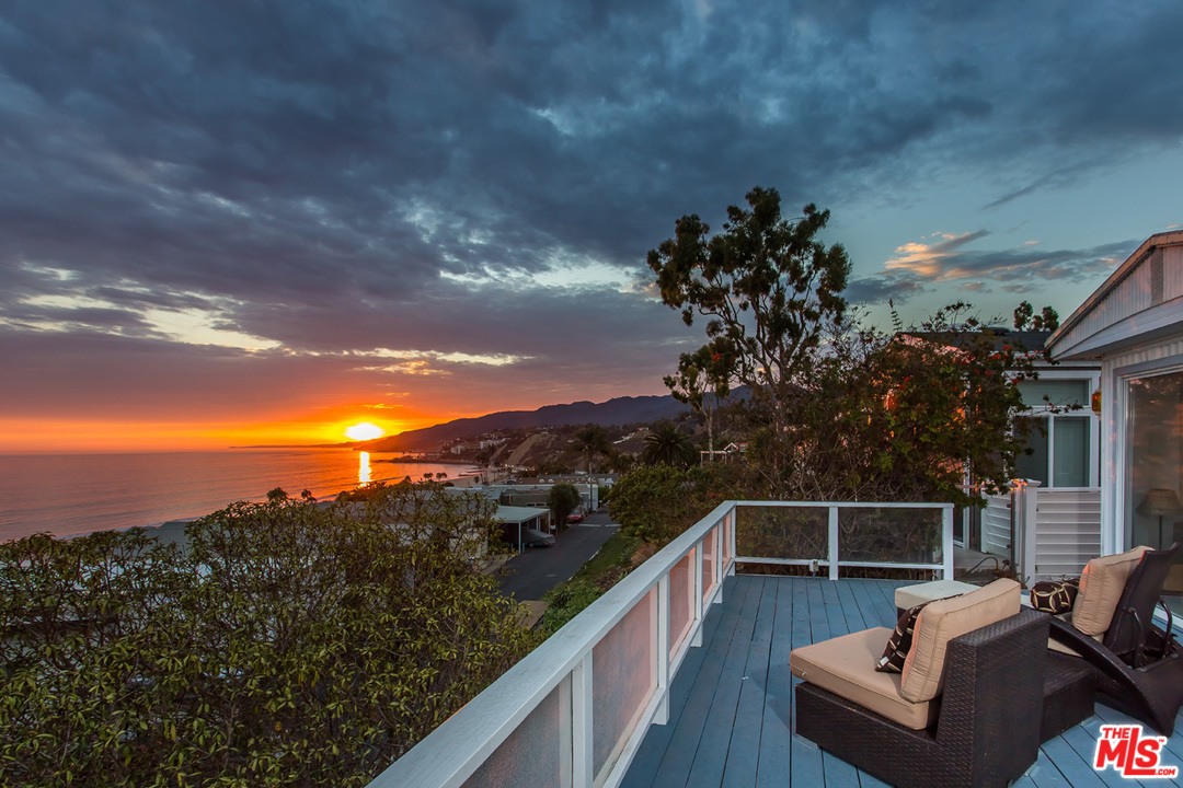a view of a balcony with two chairs