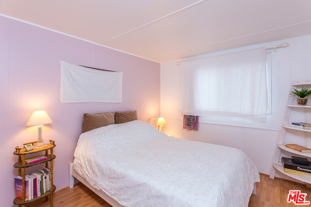 36 Copra Lane Pacific Palisades, CA 90272 - Photo 14 of 31 a bedroom with a bed and a lamp with the dresser
