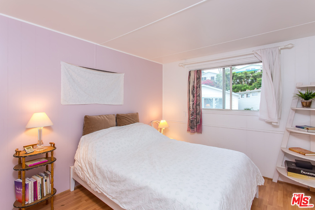 36 Copra Lane Pacific Palisades, CA 90272 - Photo 15 of 31 a bedroom with a bed and a lamp