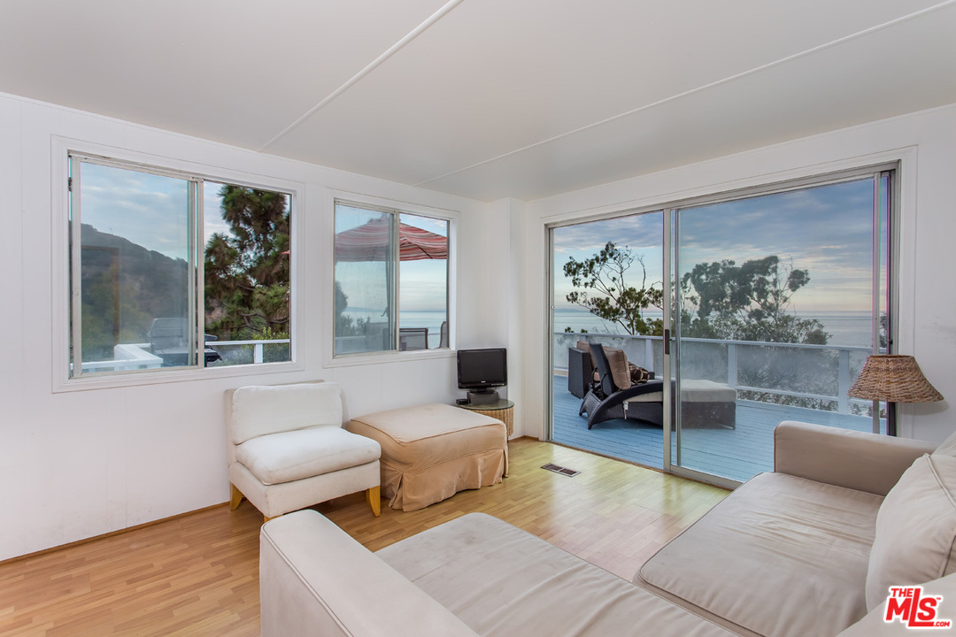36 Copra Lane Pacific Palisades, CA 90272 - Photo 19 of 31 a living room with furniture and a large window