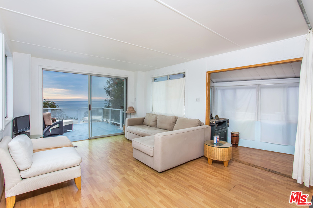 36 Copra Lane Pacific Palisades, CA 90272 - Photo 3 of 31 a living room with furniture and a wooden floor